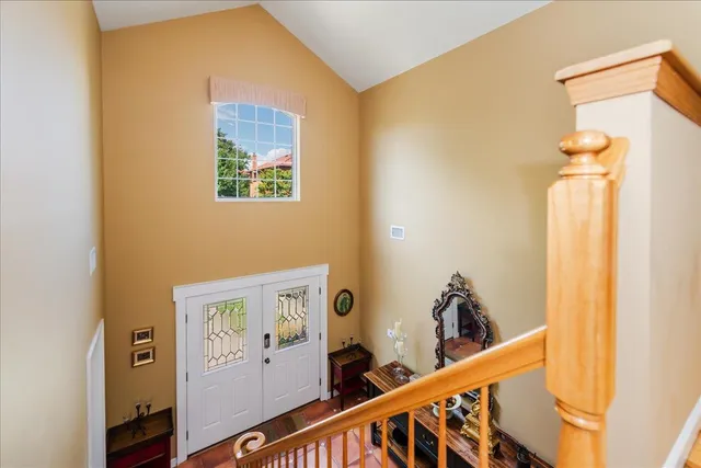 a view of a hallway with entryway wooden floor and front door