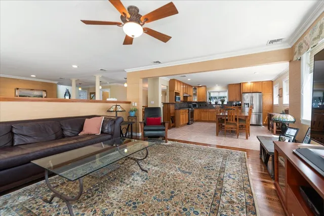 a living room with lots of furniture and kitchen view