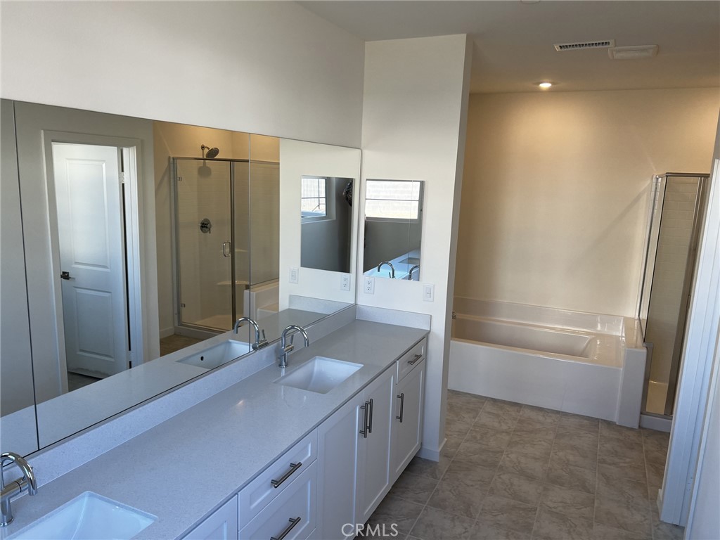 4799 Morpho Lane Fontana, CA 92336 - Photo 2 of 3 a bathroom with a double vanity sink and a mirror