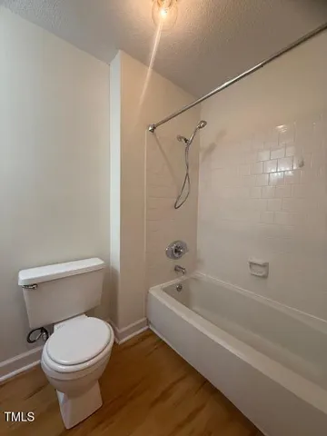 a bathroom with a toilet and a bathtub