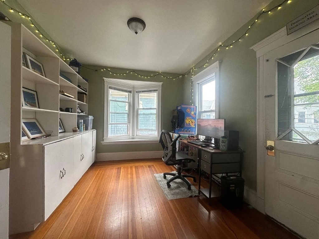 62 Bromfield Road, Unit 2 Somerville, MA 02144 - Photo 7 of 14 a kitchen with sink cabinets and wooden floor
