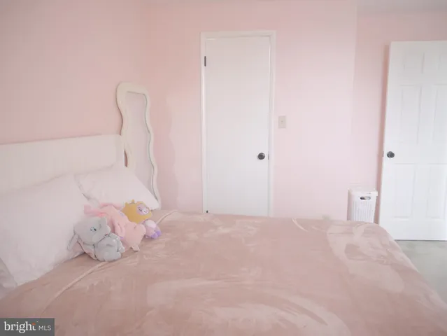 a bedroom with a bed and a chair