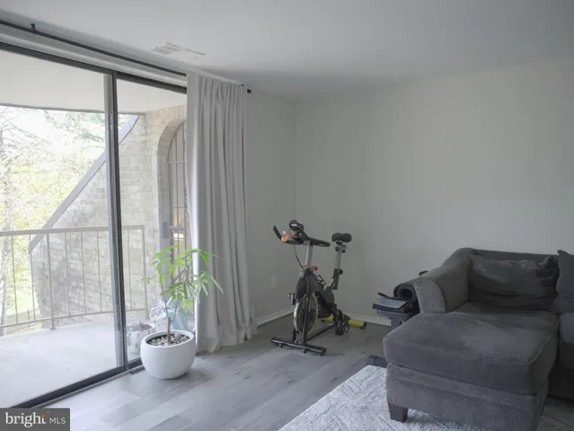a living room with furniture a window and a potted plant