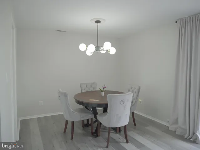 a view of a dining room with a table and chairs