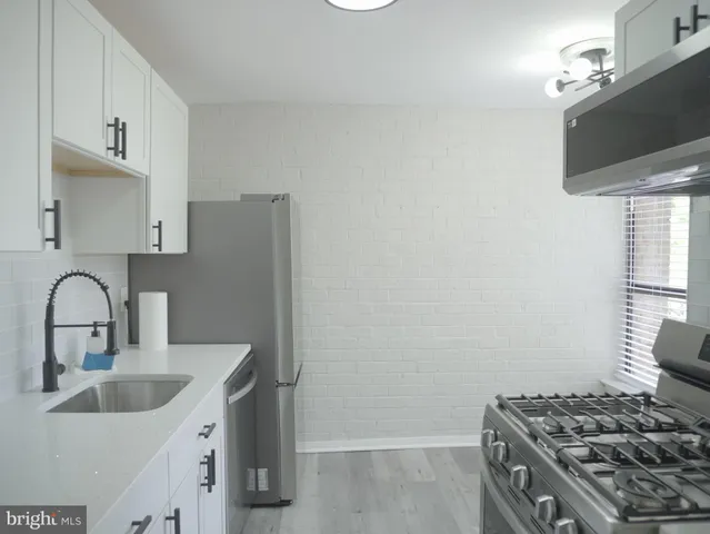 a kitchen with a sink and a stove top oven