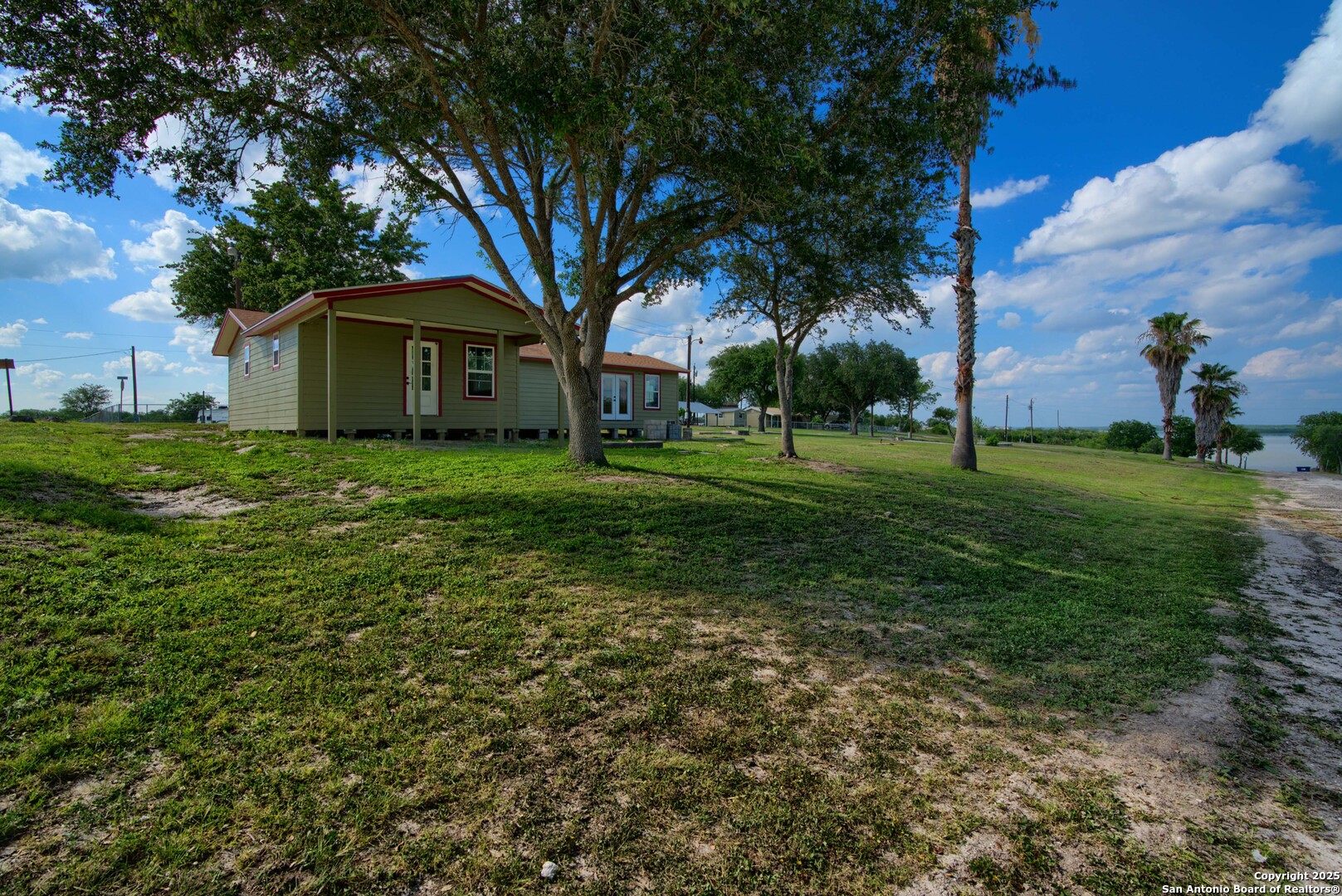101 Campbell Road 3 Road Sandia, TX 78383 - Photo 47 of 105 a view of a big house with a big yard and large trees