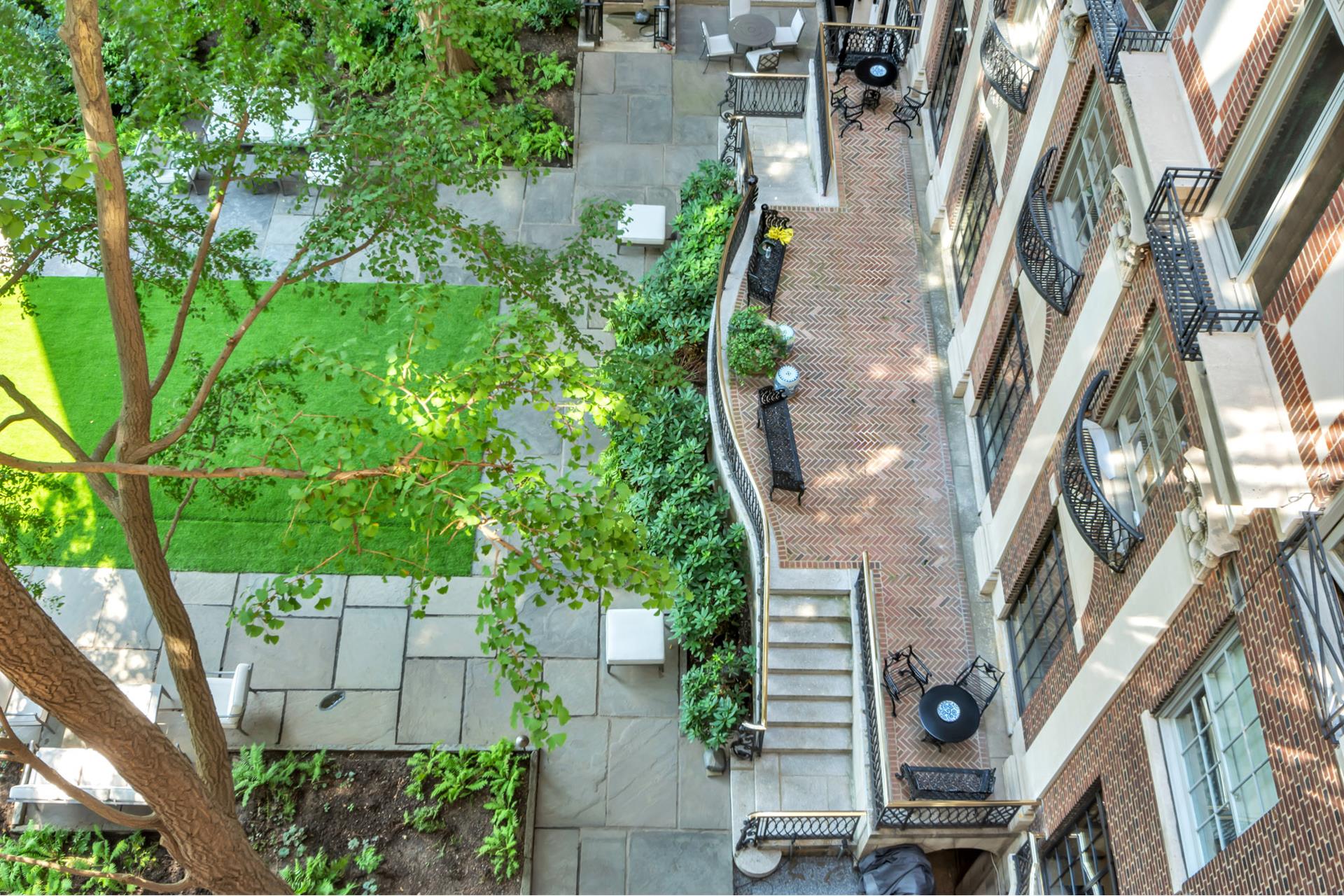 1 Sutton Place South, Unit 4C Manhattan, NY 10022 - Photo 11 of 35 an aerial view of a residential apartment building with a yard and large trees
