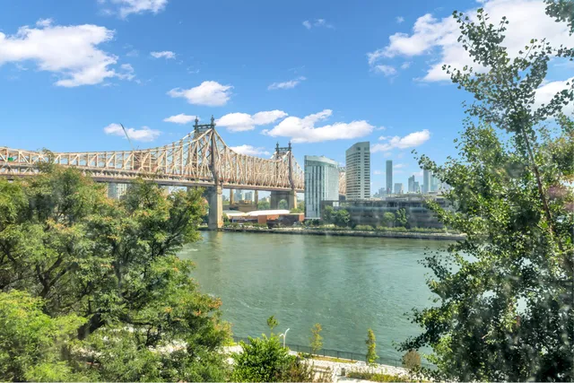 a view of an empty room with wooden floor and window