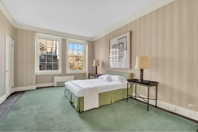 a spacious bedroom with a bed and a window