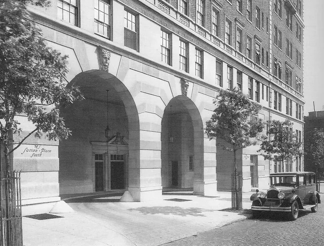a living room with furniture a fireplace and a floor to ceiling window