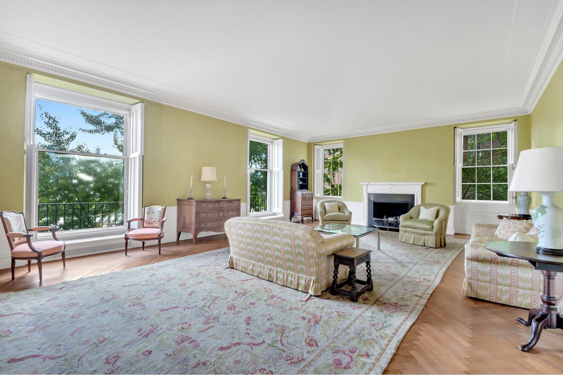 1 Sutton Place South, Unit 4C Manhattan, NY 10022 - Photo 28 of 35 a living room with furniture a fireplace and a floor to ceiling window
