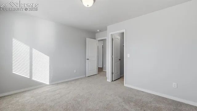 an empty room with windows and closet