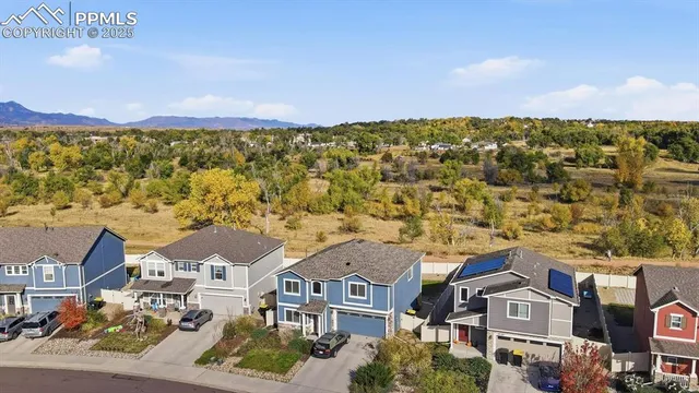 an aerial view of residential houses with outdoor space
