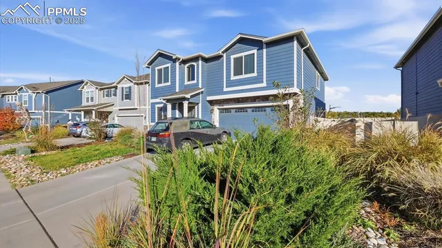 a front view of a house with a yard and fountain