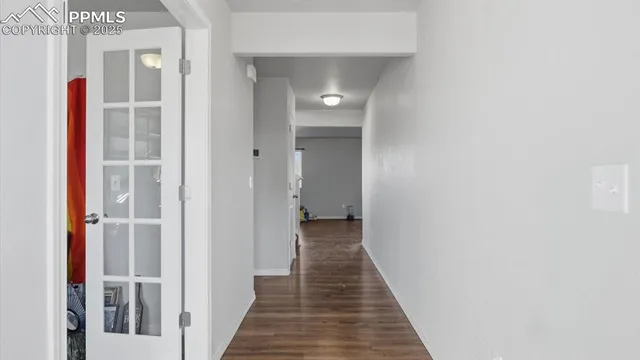 a view of a hallway with wooden floor