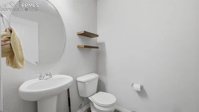 a white toilet sitting next to a bathroom sink