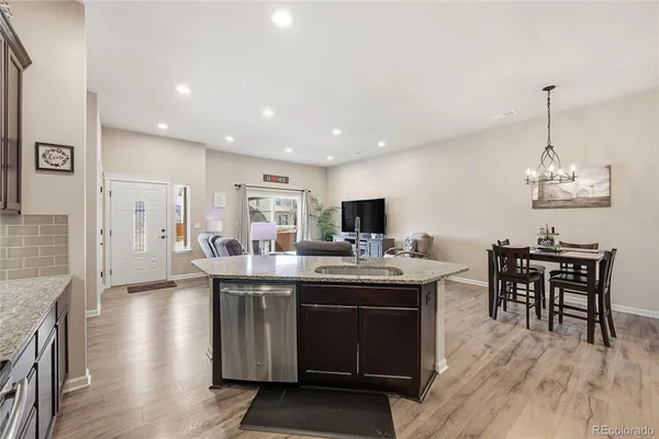 a kitchen with stainless steel appliances granite countertop a sink refrigerator and cabinets