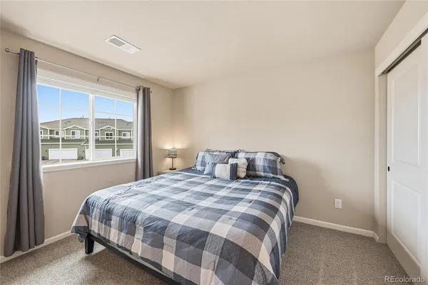 a bedroom with a bed and a closet