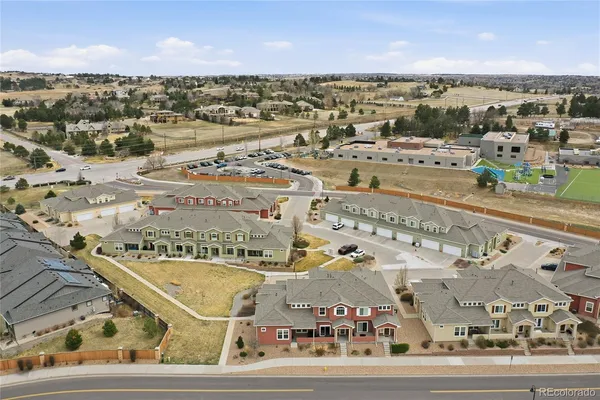 an aerial view of residential houses with outdoor space