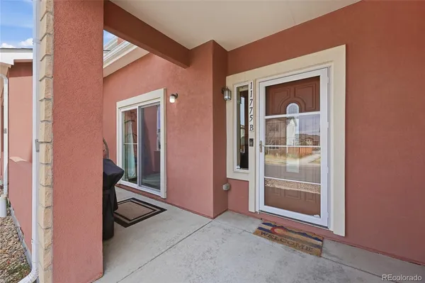 a balcony with table and chairs
