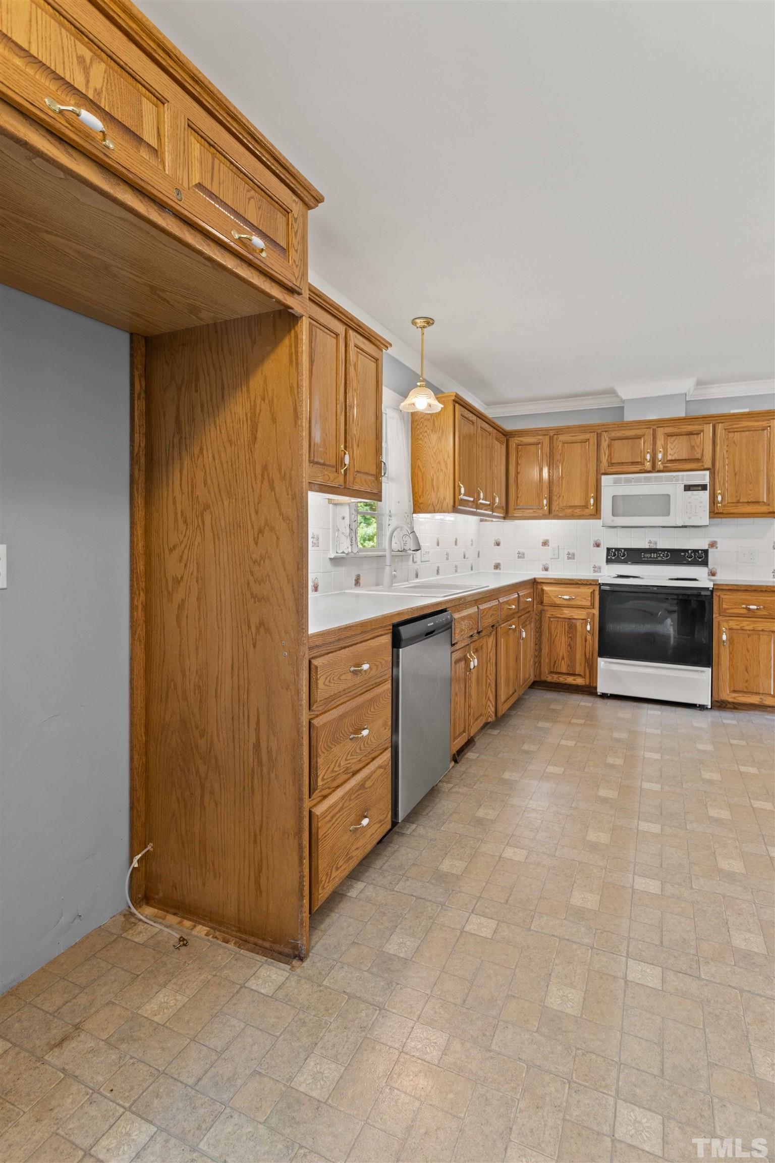 4811 Greenbrier Road Raleigh, NC 27603 - Photo 12 of 41 a large kitchen with stainless steel appliances granite countertop a sink and cabinets