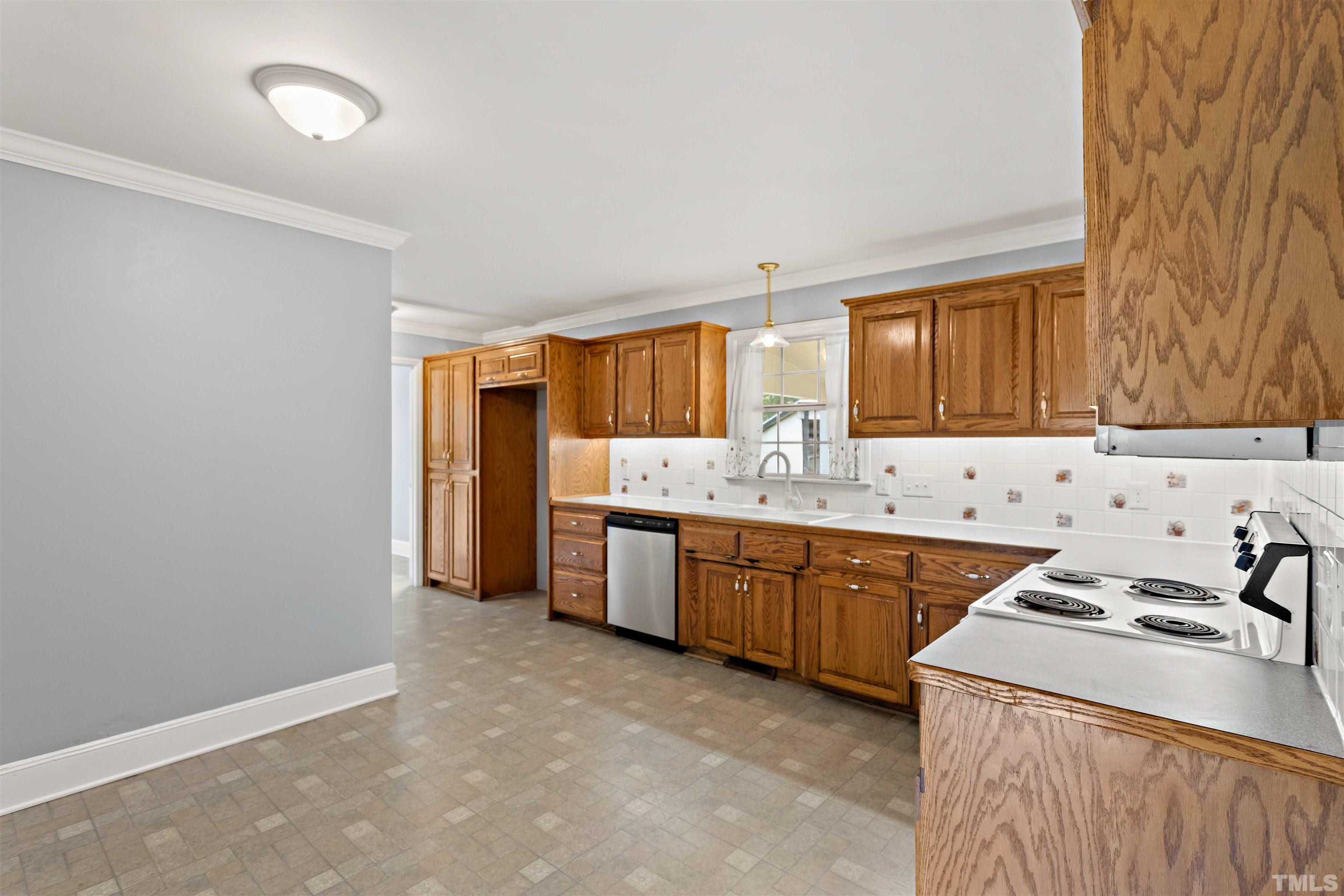 4811 Greenbrier Road Raleigh, NC 27603 - Photo 15 of 41 a kitchen with granite countertop a sink stove and refrigerator