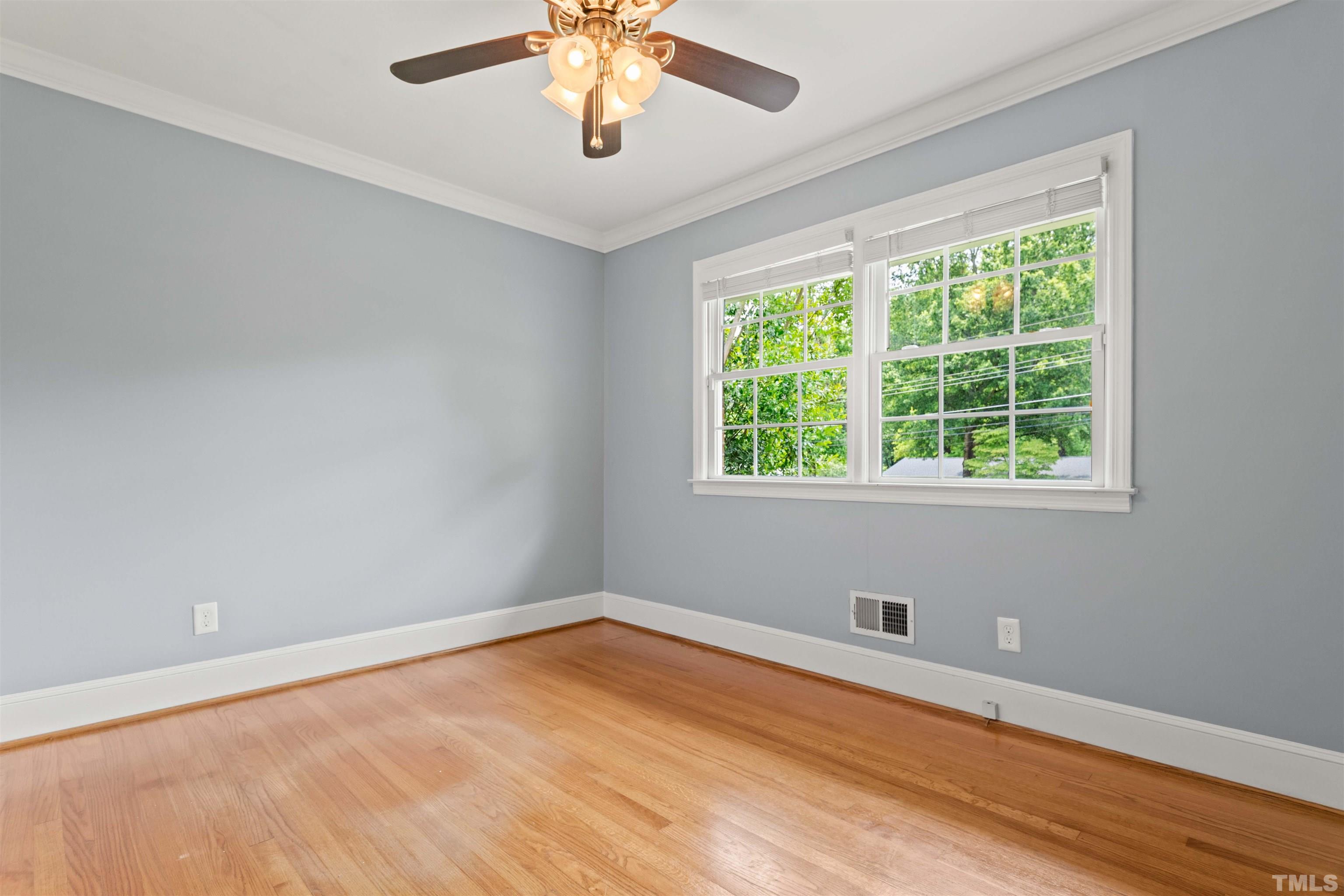 4811 Greenbrier Road Raleigh, NC 27603 - Photo 18 of 41 a view of an empty room with a window and wooden floor