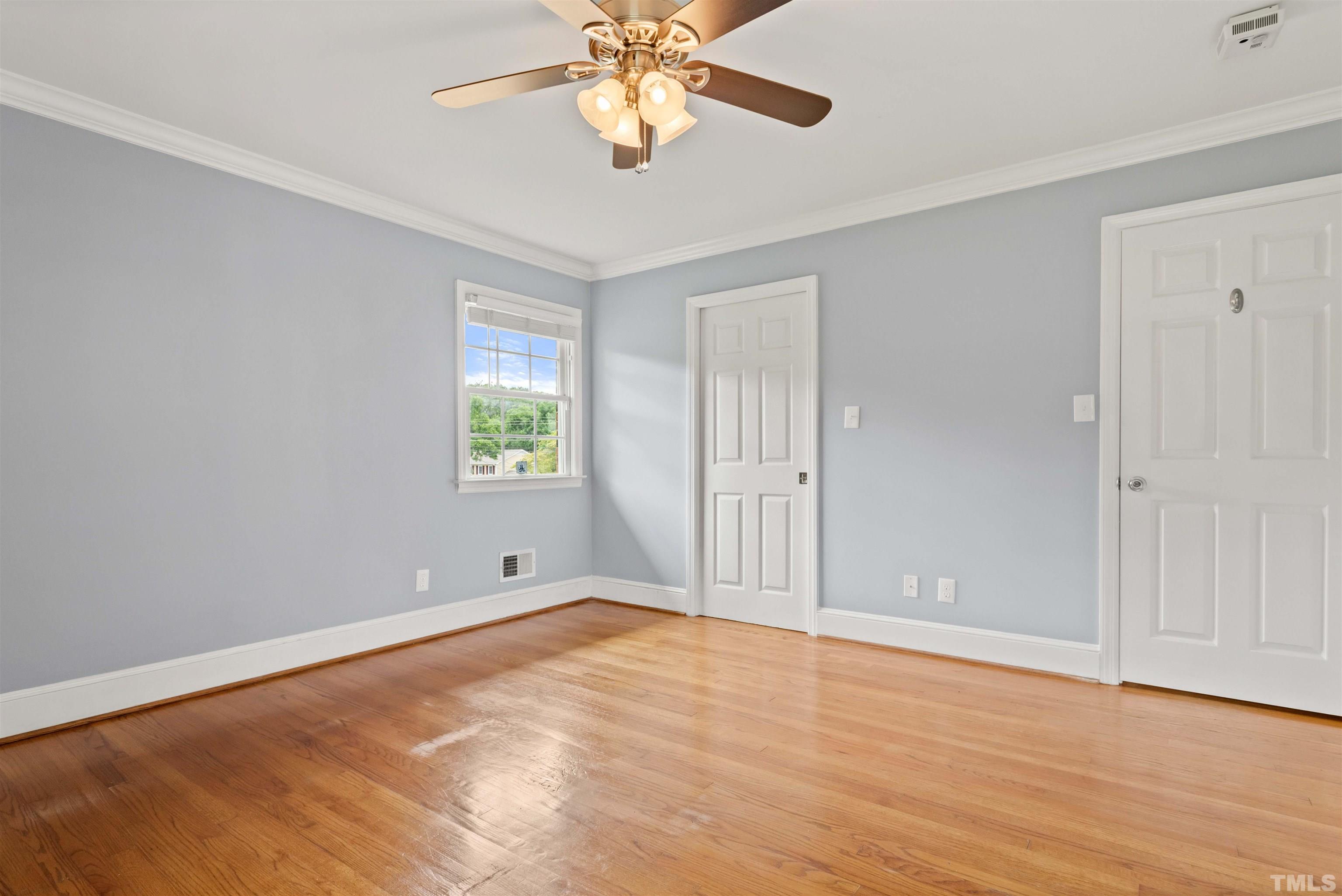 4811 Greenbrier Road Raleigh, NC 27603 - Photo 25 of 41 a view of an empty room with window and wooden floor