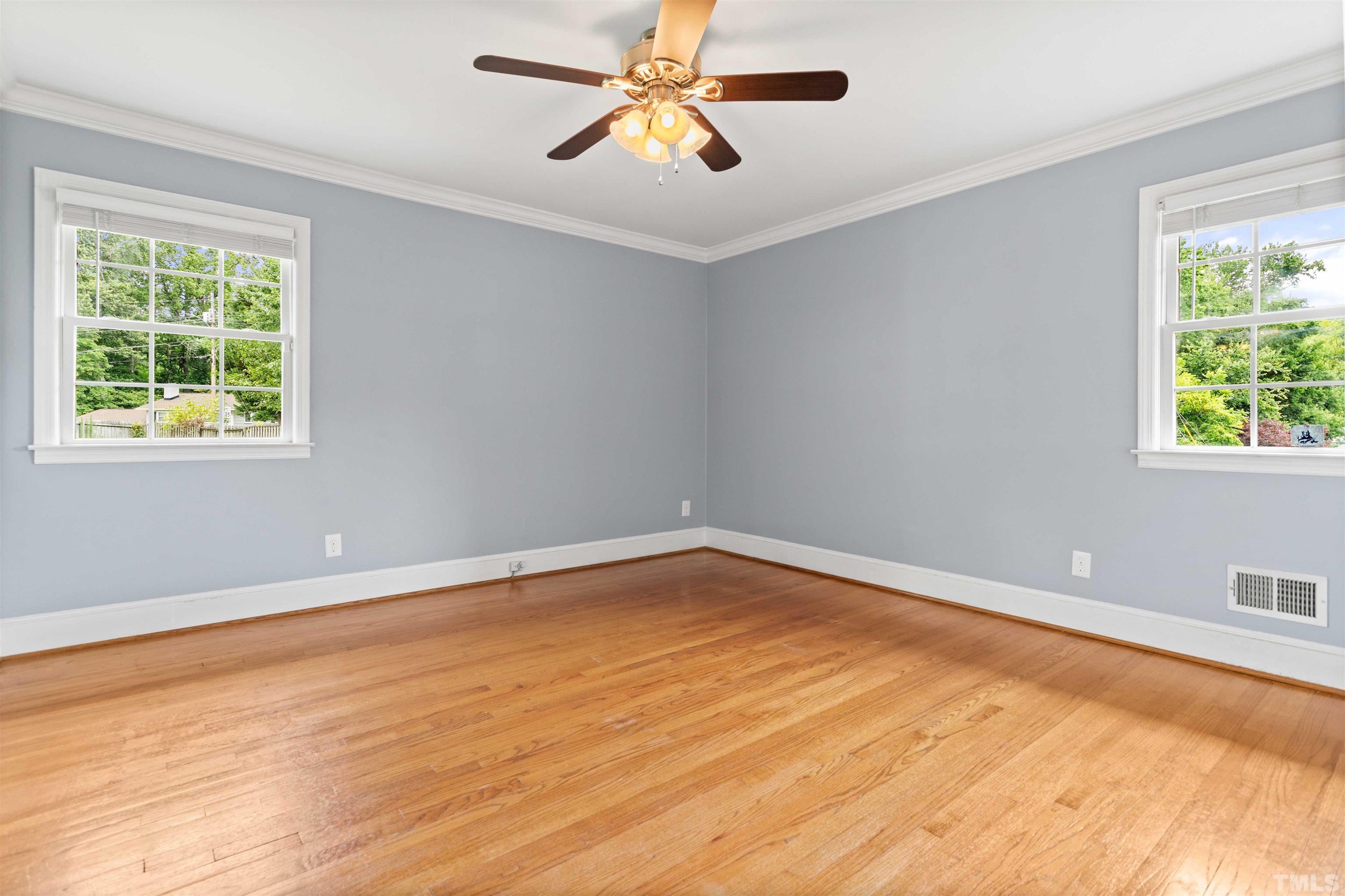 4811 Greenbrier Road Raleigh, NC 27603 - Photo 26 of 41 a view of an empty room with window and wooden floor