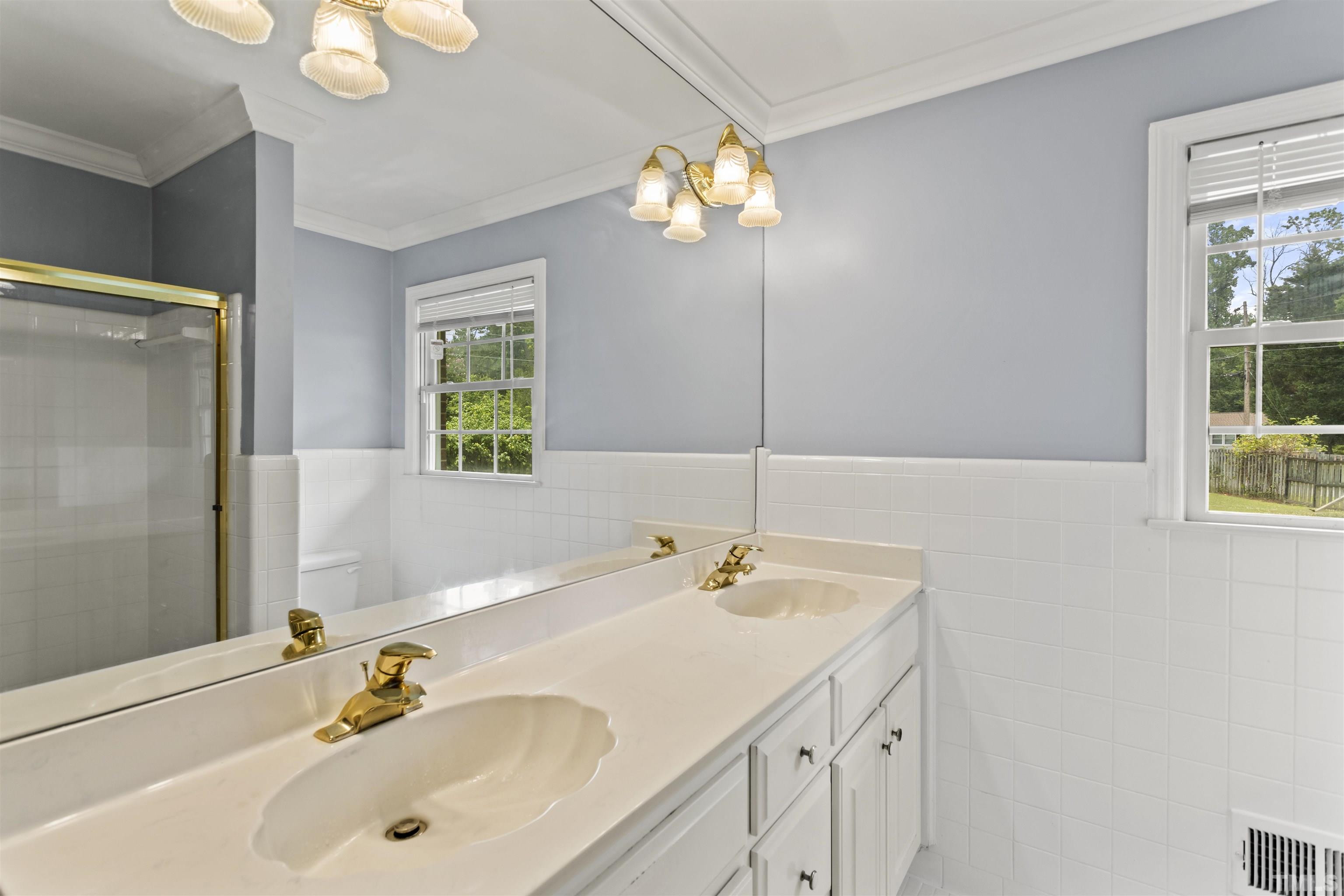 4811 Greenbrier Road Raleigh, NC 27603 - Photo 30 of 41 a bathroom with a sink and a large mirror