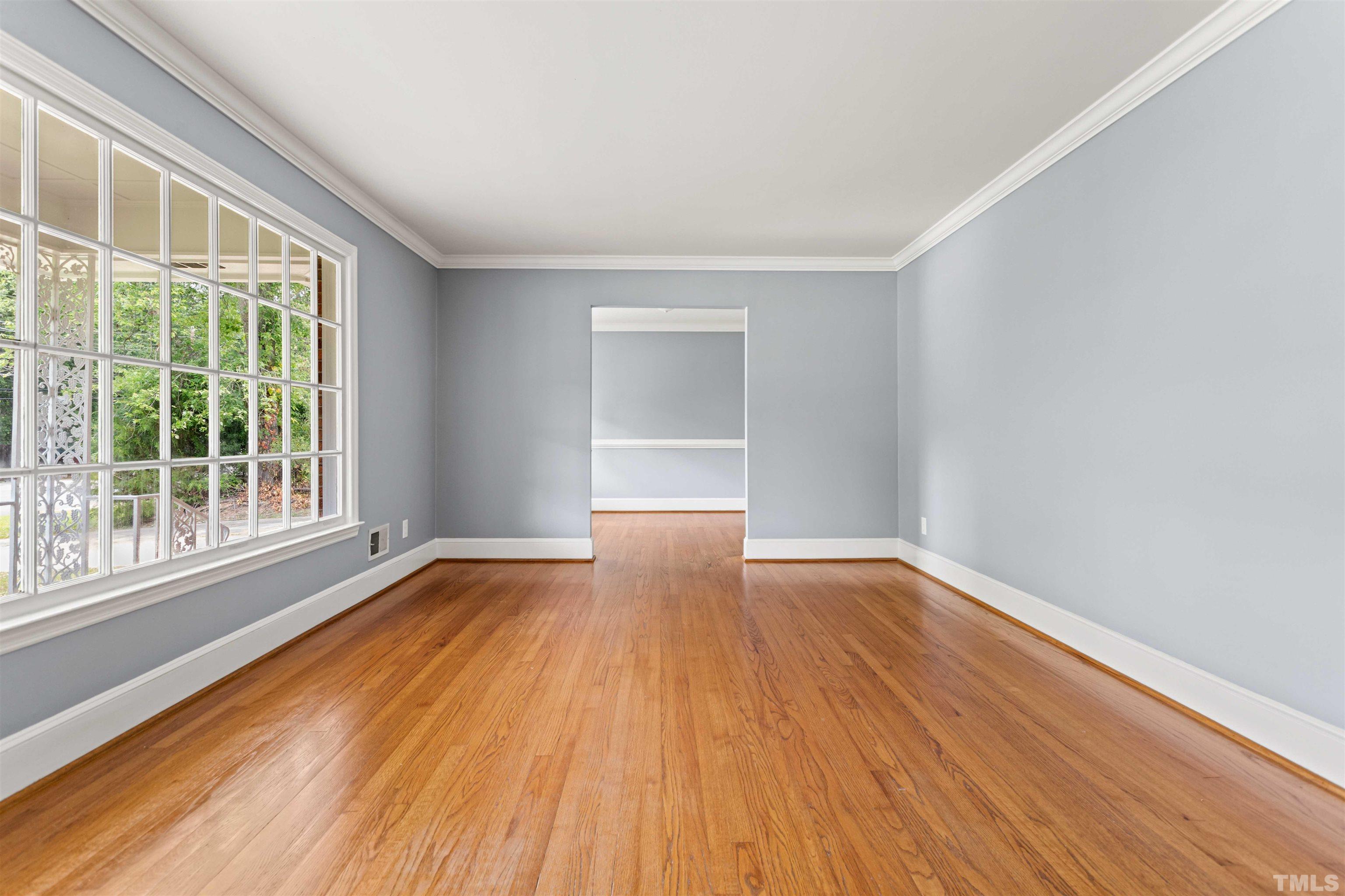 4811 Greenbrier Road Raleigh, NC 27603 - Photo 36 of 41 a view of an empty room with wooden floor and a window
