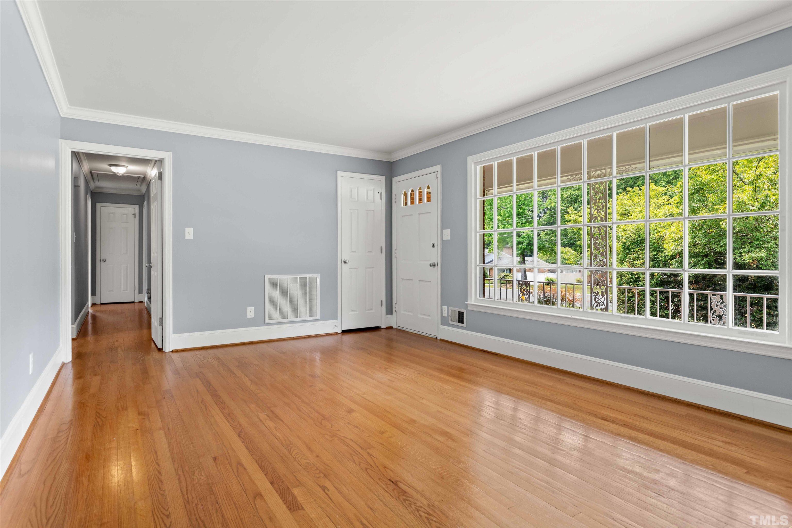 4811 Greenbrier Road Raleigh, NC 27603 - Photo 37 of 41 a view of an empty room with wooden floor and a window