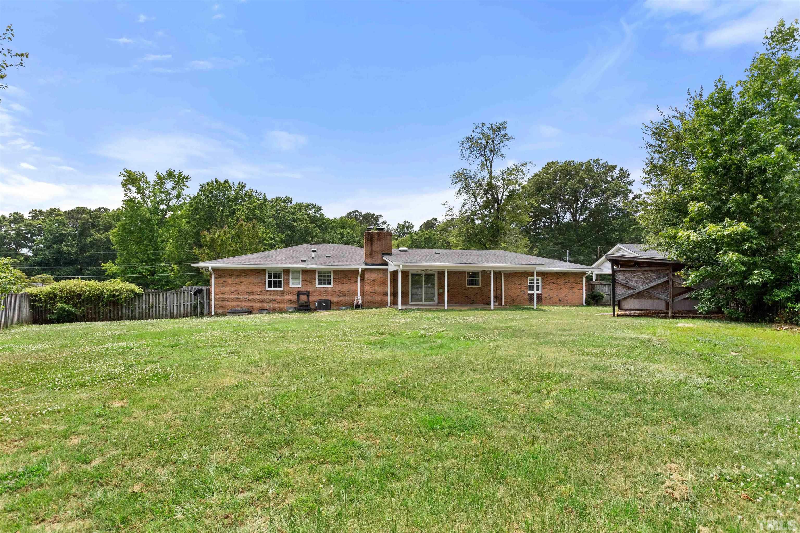 4811 Greenbrier Road Raleigh, NC 27603 - Photo 4 of 41 a front view of a house with a garden