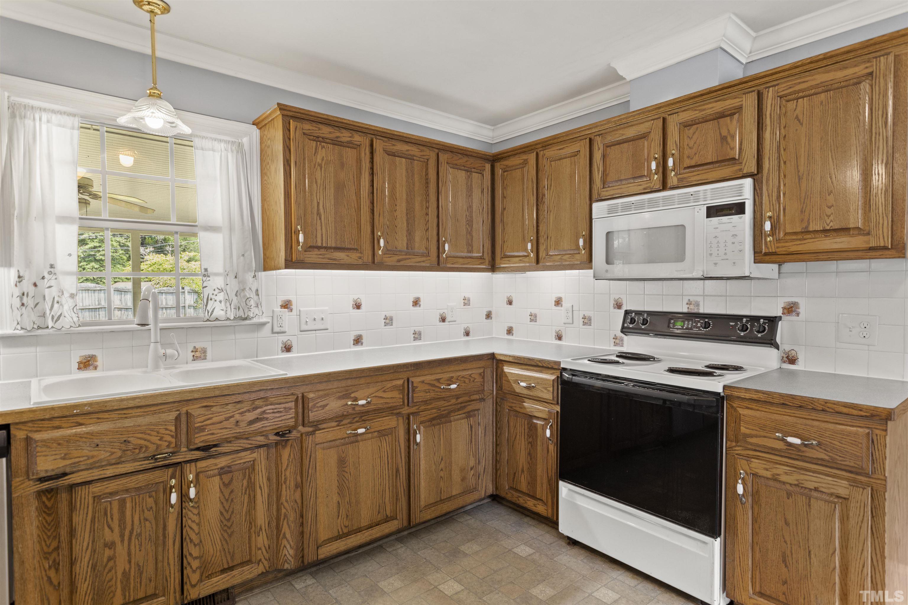 4811 Greenbrier Road Raleigh, NC 27603 - Photo 6 of 41 a kitchen with cabinets appliances and a sink