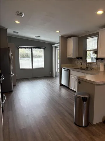 an open kitchen with sink and cabinet