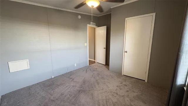 a view of a room with a light fixture and closet