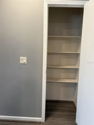 a view of walk in closet with empty racks