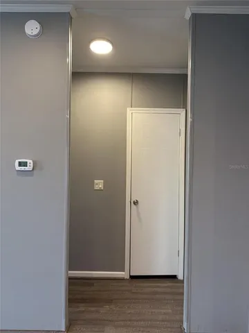 a view of an empty room with wooden floor