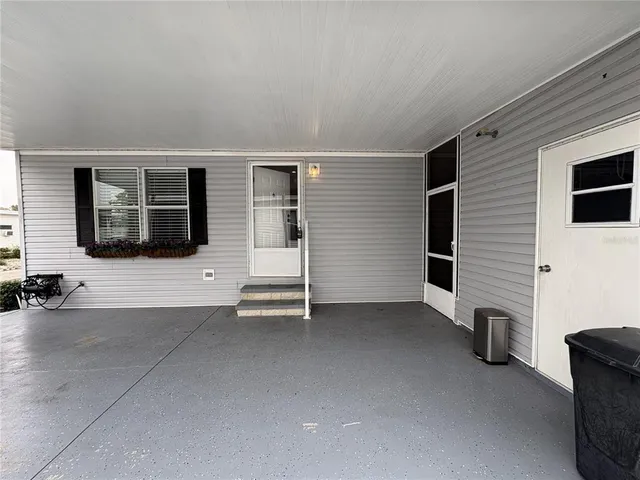 a view of a livingroom with furniture and floor to ceiling window