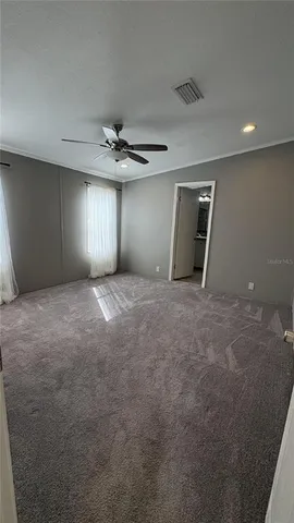 a view of a livingroom with a ceiling fan and window