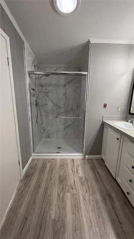 a view of a room with wooden floor and white walls