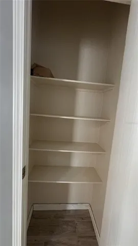 a view of walk in closet with empty racks