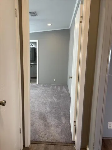 a dining room with furniture and a floor to ceiling window
