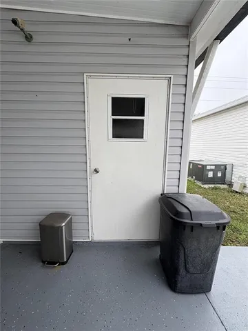 a dining room with furniture and a window