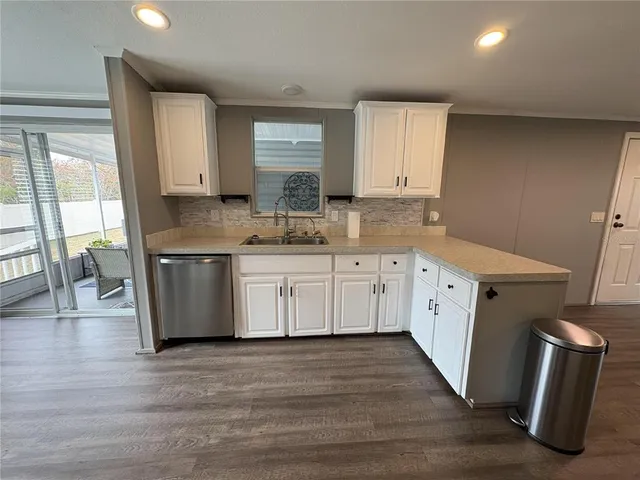 a kitchen with a sink stove and cabinets