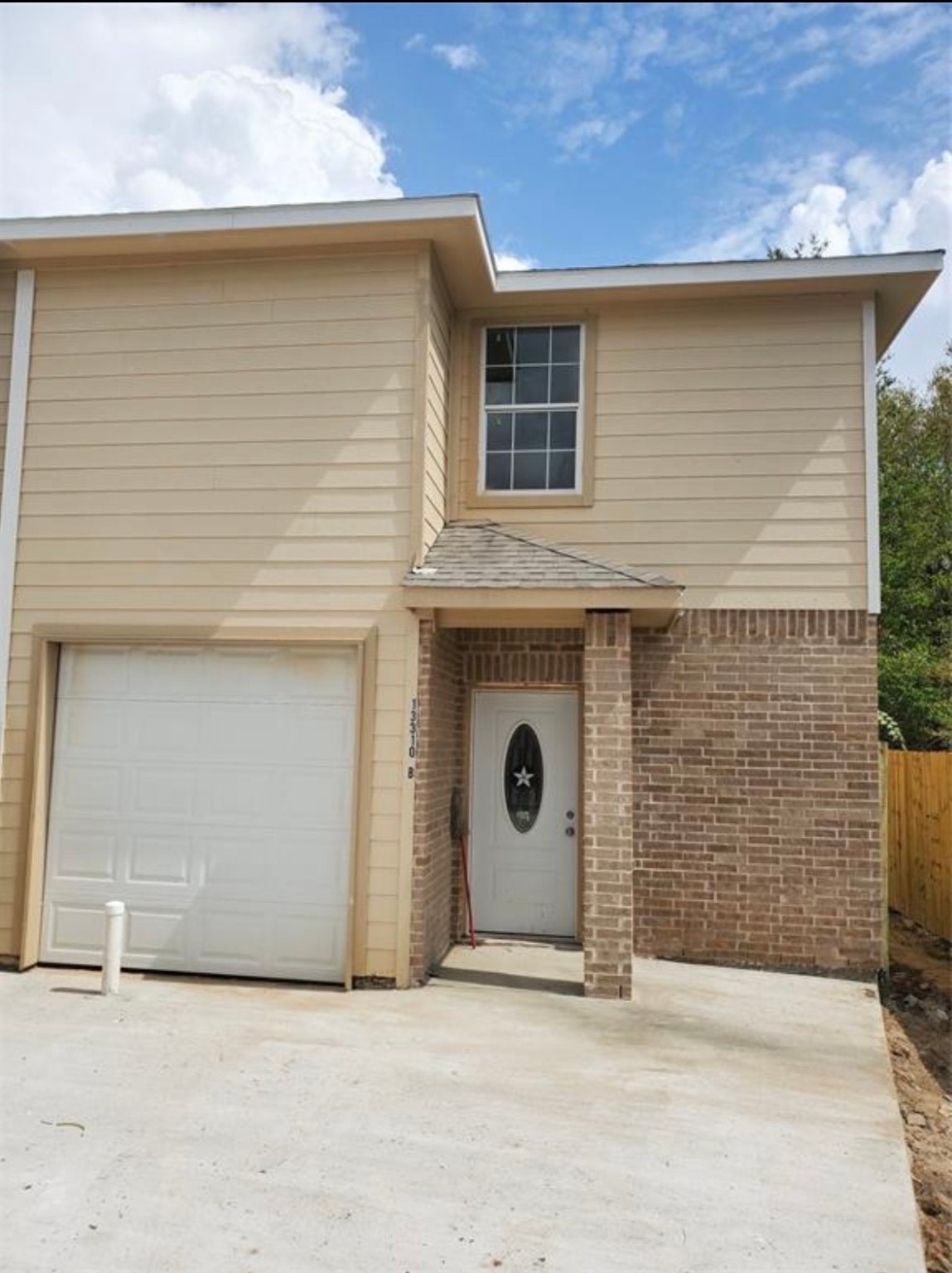13310 Robertcrest Street, Unit B Houston, TX 77039 - Photo 2 of 6 a front view of a house with an entrance and a garage