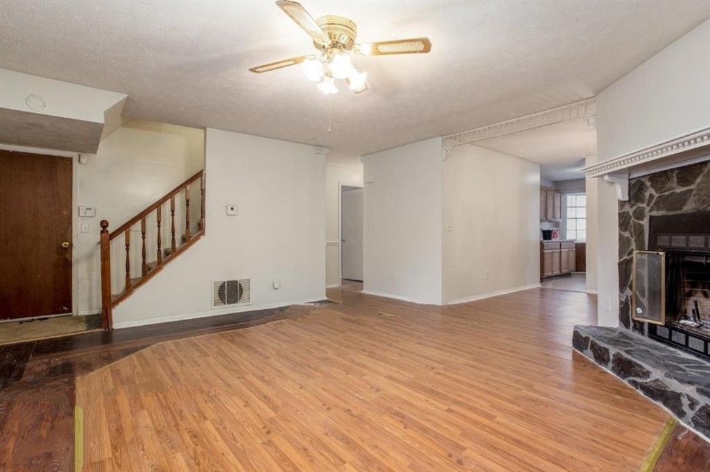 602 Pine Tree Trail Atlanta, GA 30349 - Photo 2 of 7 a view of empty room with fireplace and wooden floor