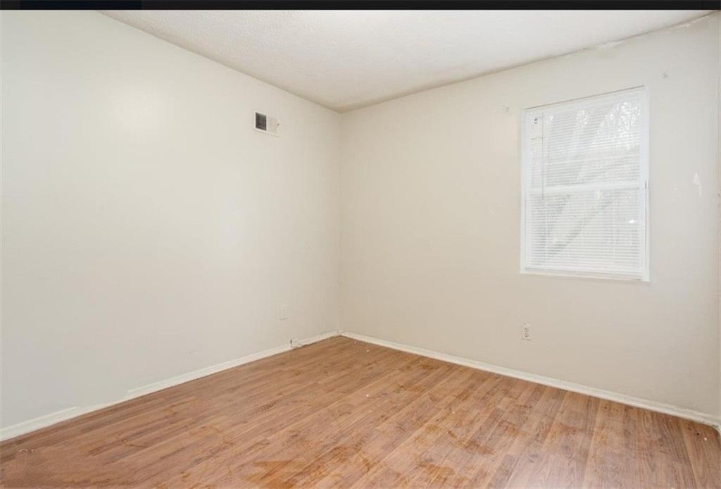 602 Pine Tree Trail Atlanta, GA 30349 - Photo 5 of 7 a view of empty room with wooden floor