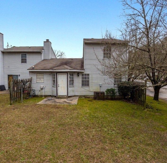 602 Pine Tree Trail Atlanta, GA 30349 - Photo 7 of 7 a front view of a house with a garden and trees