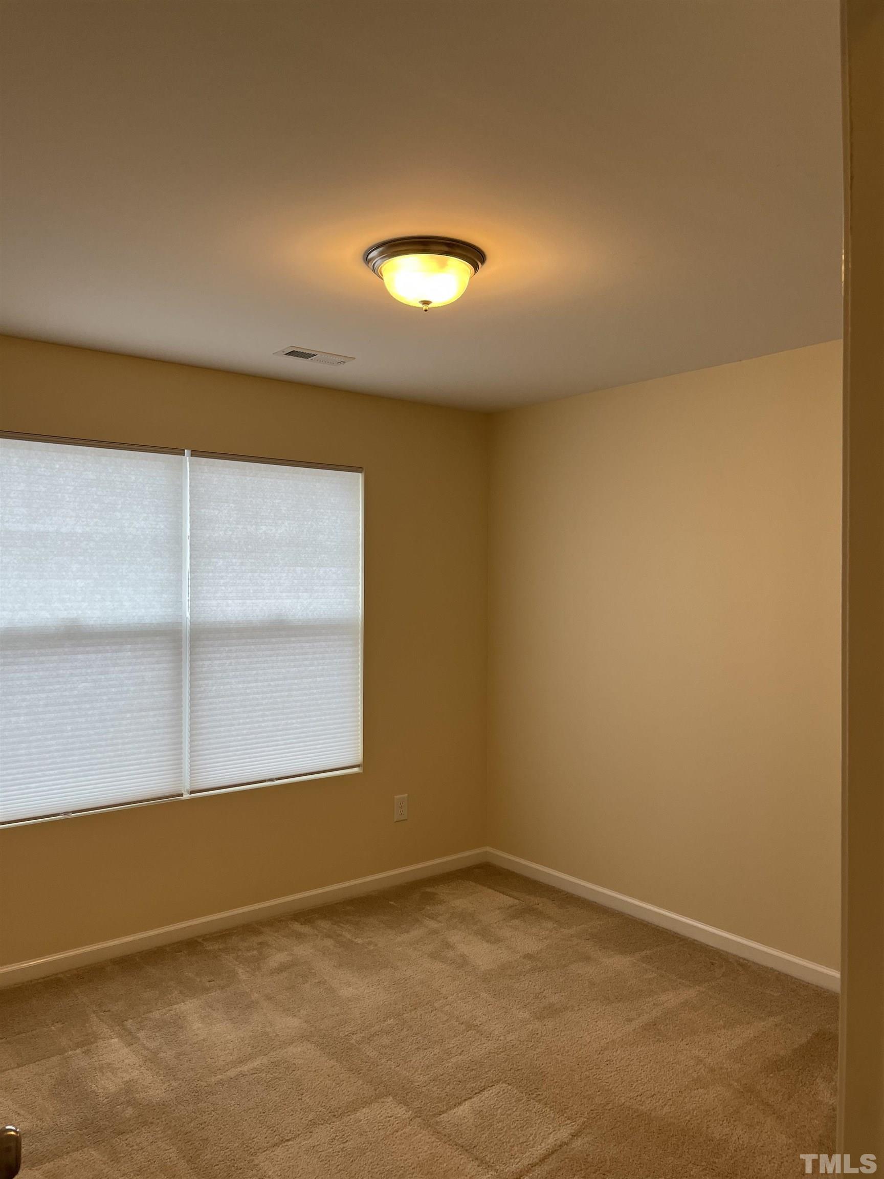 2499 Longshadow Drive Graham, NC 27253 - Photo 13 of 14 an empty room with a empty space and a window